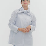 Model wearing white Sailor Ribbon Shirt with distinctive marine collar and decorative stitching details.
