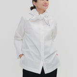 Model wearing white Sailor Ribbon Shirt with distinctive marine collar and decorative stitching details.